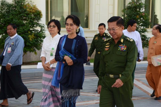 Myanmar military commander-in-chief Senior General Min Aung Hlaing and Myanmar opposition leader Aung San Suu Kyi arrive to attend a high-level meeting at the President's resident office in Nay Pyi Taw on 31 October 2014. (Image: MNA)