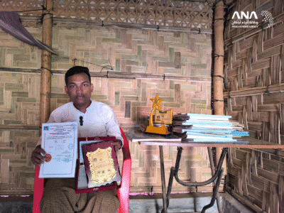 Salay Ahmed showing awards he earned to ANA (Image: ANA)